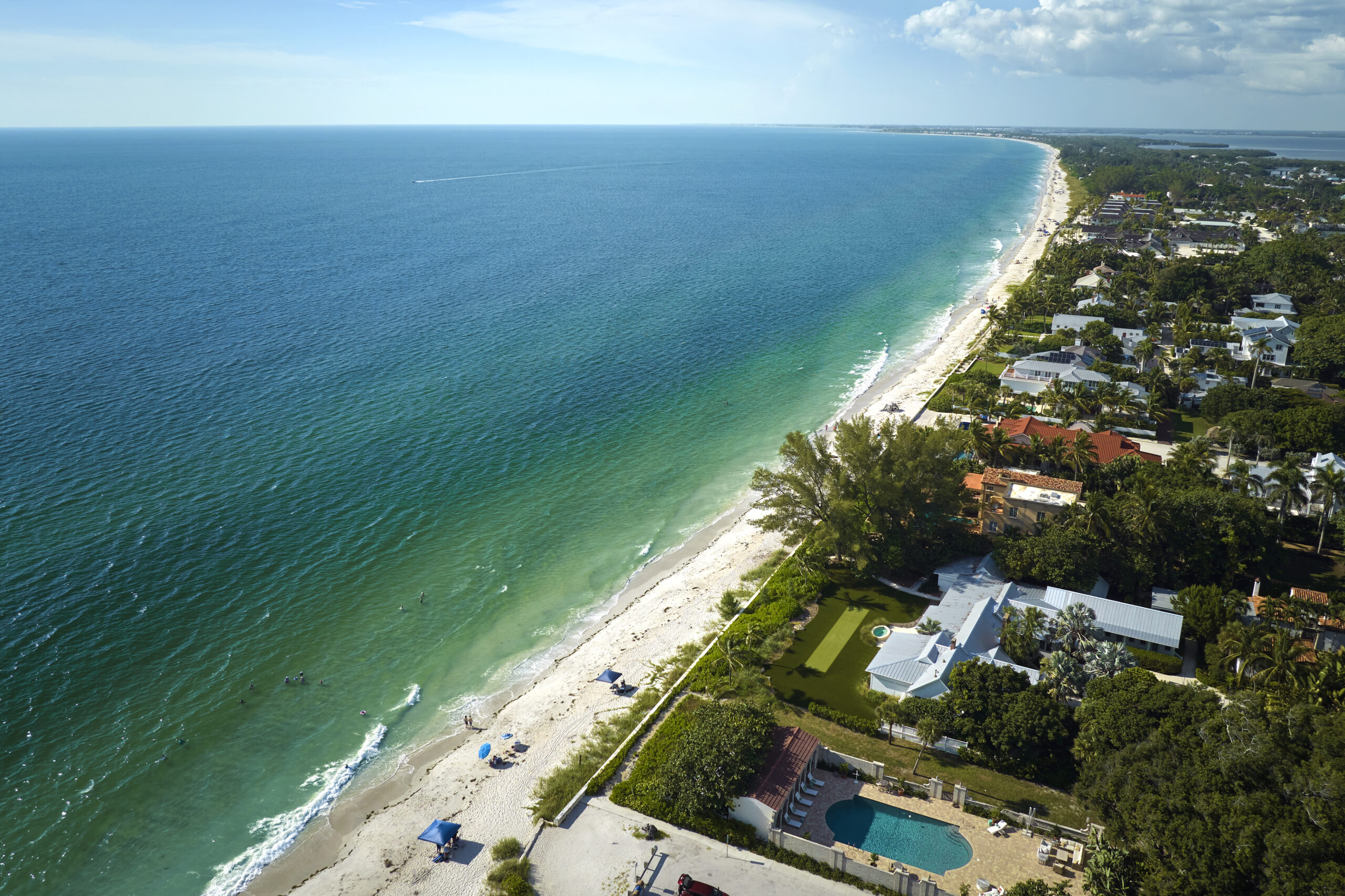 Aerial view of expensive residential houses in island small town Boca Grande on Gasparilla Island in southwest Florida. American dream homes as example of real estate development in US suburbs.